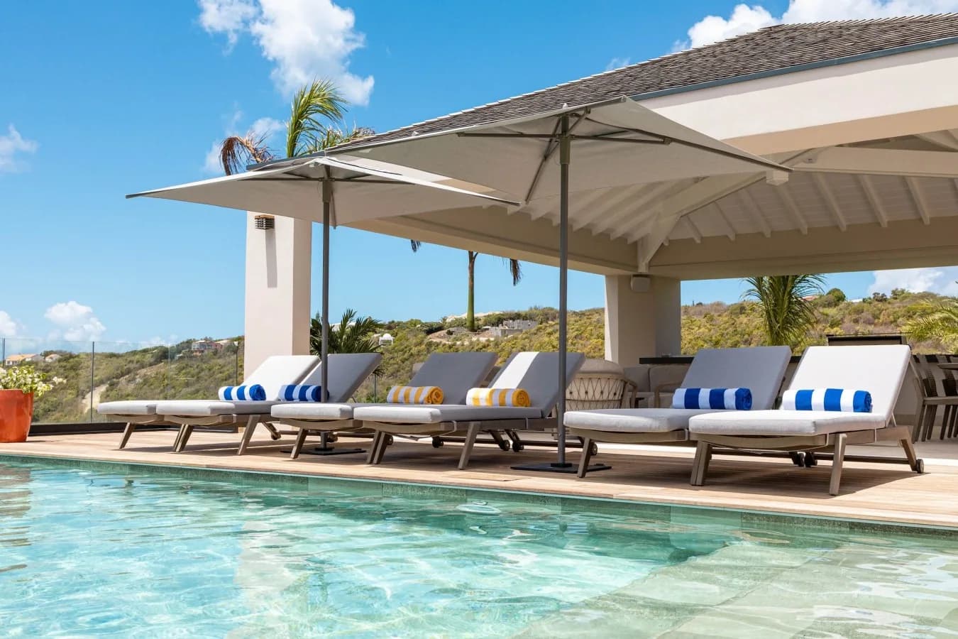 Sun loungers and parasols by the pool